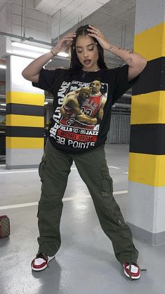 a woman is standing in an empty parking garage with her hands on her head and wearing red shoes