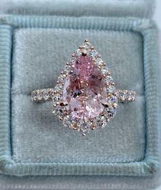 Gorgeous Pear Morganite Diamond Ring Rose Gold. Calling all pear lovers, this ring is simply stunning! The halo of diamonds frames this beautiful morganite gem perfectly. The diamonds are very sparkling, set with graduated sizes. Excellent craftsmanship, all diamonds are set smooth. You see sparkles from every angle, even the prongs have diamonds set. Very comfortable ring to wear, the band doesn't feel bulky. This ring has the wow factor. This is my best quality morganite. The diamonds are clea Luxury Gia Certified Pear-shaped Wedding Ring, Pear-shaped Diamond Ring With Gemstone, Pink Pear Engagement Ring, Pink Pear-shaped Gemstone Rings, Dazzling Pear-shaped Ring With Rose Cut Diamonds, Gia Certified Pear-shaped Cubic Zirconia Ring, Dazzling Pear-shaped Rose Cut Diamond Rings, Gia Certified Teardrop Ring For Anniversary, Pear-shaped Sapphire Ring With Rose Cut Diamonds