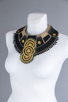 Extra large statement black Cleopatra beaded necklace. Original Egypt jewelry piece. Black necklace with gold universe ornaments. Unique and one of a kind beaded jewelry design by Rasaviljewelry. I have used gold and black 10 and 9 size beads. Metal buckle in the middle, black felt, welshman 0.18 mm, black. Green Czech glass, yellow- gold glass beads, natural black leather on the back side. It could be made with faux - vegan leather, please leave the note under the order. NECKLACE WILL BE MADE J Gold Bib Necklace With Large Beads For Jewelry Making, Gold Necklaces With Black Beads For Party, Adjustable Gold Beads Necklace, Gold Choker With Black Beads For Parties, Bohemian Gold Bib Necklace With Colorful Beads, Gold Beaded Bohemian Necklaces, Gold Beaded Round Choker, Gold Bib Necklace With Colorful Beads, Unique Gold Beaded Choker