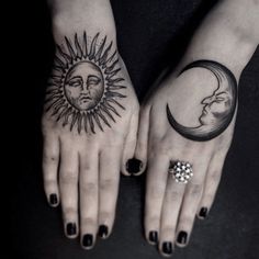 two hands with sun and moon tattoos on them