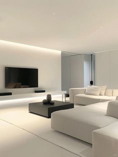 a modern living room with white furniture and lighting