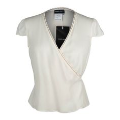 Guaranteed authentic Giorgio Armani Black Label elegant and chic wrap top. Simple in winter white silk. V neckline with the wrap 'tie' going through loops along the edge of the top.A small cap sleeve.NEW or NEVER WORN. Price tag of $875.00 attached.Please check measurements - runs small.final saleSIZE 44 USA SIZE 8TOP MEASURES: LENGTH 19"UNDERARM TO UNDERARM 18"WAIST 16.25" CONDITION:NEW or NEVER WORN Elegant Luxury Evening Wrap Top, Elegant Wrap Blouse For Formal Occasions, Elegant Wrap Top For Workwear, Elegant Wrap Top For Work, Fitted Wrap Blouse For Formal Occasions, Elegant Formal Wrap Top, Elegant Spring Wrap Top, Elegant Wrap Top For Spring, Formal Fitted Wrap Top