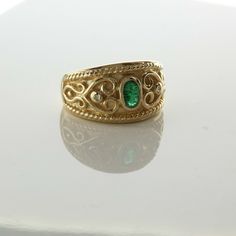 14K Yellow Gold Emerald and Diamond Ring, dark oval emerald center with round diamond accents wirework scrolls, Ring size 6.25, Circa 1980, 6.8 grams SKU# BB263R10 This listing contains photographs of the actual item you will receive. Our items are in excellent condition with little or no signs of wear and many are one of a kind pre-owned estate finds. Please look closely at the pictures in this listing as they are part of the product description. Please read the description, as any imperfection Heirloom Gold Emerald Ring With Oval Cabochon, Antique Gold Emerald Ring With Oval Cabochon, Antique Emerald Ring In Gold With Oval Cabochon, Oval Gold Emerald Ring With Intricate Design, Gold Emerald Ring With Intricate Design, Oval Shape, Gold Emerald Ring For May Birthstone, Oval Shape, Vintage Oval Emerald Jewelry, Victorian Oval Yellow Gold Emerald Ring, Vintage Oval Emerald Diamond Ring