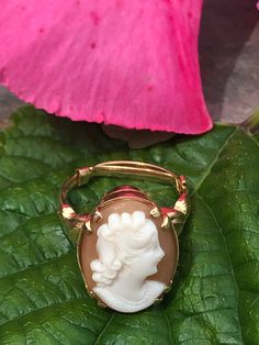 This 14K gold ring comes from a Southern Belle's collection. The 14K Gold setting holds a hand carved Cameo of a pretty girl with a bead/pearl necklace. This piece has a 14K gold ring size reducer. With this size reducer it is 6.5 size. We are presenting this ring to include the size reducer for your convenience. If you do not want the size reducer, please send us a message and we will adjust the price of the ring according and measure the size again. We will gladly ship this ring free within th Luxury Vintage Cameo Ring, Antique Cameo Ring Collectible, Cameo 14k Gold Rings For Collectors, Victorian Gold Cameo Rings, Collectible 14k Gold Cameo Rings, Vintage Gold Carved Ring, 14k Gold Cameo Rings For Collectors, Gold Oval Cameo Rings, Vintage Gold Cameo Ring