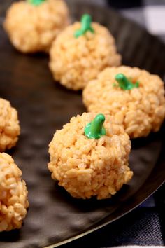 rice krispy treats are arranged on a black plate