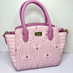 Item: New Condition Luv Betsey By Betsey Johnson Kassie Crossbody Purse With Detachable Strap For Versatile Handle Style. Super Cute Pink + Purple Quilted Heart Design. Gold Tone Hardware With Lips Zipper. Has Main Zipper Compartment And One Inner Zipper Pocket Materials: Body 100% Polyurethane, Lining 100% Polyester Approx. Measurements: 12” Wide, 5” Deep, 4” Drop Handles, 8.5” Tall, 45” Strap (Can Be Adjusted) Condition: One Very Small Call Out On Side Of Bag, Otherwise Like New - Clear Protec Heart Purple, Betsey Johnson Bags, Bag Handle, Crossbody Purse, Heart Design, Cute Pink, Betsey Johnson, Purses Crossbody, Pink Purple