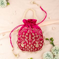 "Magenta Pink Luxury Velvet Fabric Zardozi Sequin Embroidered Woman Potli Bag | Bridesmaid Fashionable Gifting Bag | Velvet Drawstring Purse Package Contents: 1 Size: 10\" x 8\" Designed with the heart, this beautiful Potli or batawa bag are eye catchy and made of premium material. Key Features: Embroidery art work. (zardosi work). This potli is good match with both Indian and western outfits and are superb for wedding and festive parties. This would be best complement to your designer saree, lenhga or any other kind of dress. This is the combination of traditional and modern embroidery work. This is enough to keep your accessories and all needed essentials and it can be a best gift for any woman." Festive Red Embroidered Pouch, Pearl Embroidered Potli Bag As Gift, Red Embroidered Pouch For Party, Red Embroidered Party Pouch, Pink Pearl Embroidery Bags For Wedding, Red Embroidered Shoulder Bag For Wedding, Pink Embroidered Party Pouch, Embroidered Rectangular Potli Bag, Festive Red Embroidered Bag