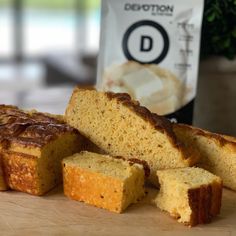 some slices of cake sitting on top of a wooden cutting board next to a bag of coffee