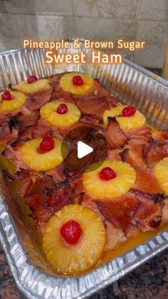 a pan filled with pineapple and brown sugar sweet ham on top of a counter