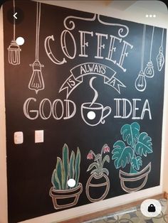 a chalkboard with plants and hanging lights on it that says coffee is always a good idea