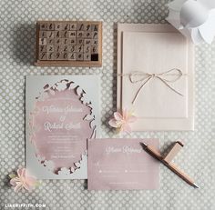 the wedding stationery is laid out on the table