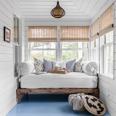 a living room with white walls and blue flooring