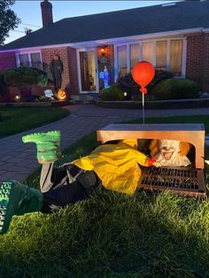 a man laying on top of a bed in the grass next to a red balloon