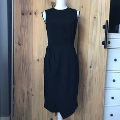 New. Never Worn. Fitted. Zip Closure And Hook-Eye In Back. Lining Top. Material: Shell: 70% Triacetate, 30% Polyester, Lining: 100% Polyester. Flat Measurement: From Front Neck To Hem (Longest Point) Approx. 39 Inches Long. No Trades, No Holds Black Midi Dress With Side Zipper, Chic Asymmetrical Midi Dress For Office, Black Sleeveless Asymmetrical Dress For Work, Chic Knee-length Midi Dress With Side Zipper, Knee-length Asymmetrical Office Dress, Sleek Black Sleeveless Asymmetrical Dress, Elegant Asymmetrical Dress For Work, Black Midi Dress With Asymmetrical Hem For Work, Chic Sleeveless Asymmetrical Dress For Work