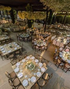 an outdoor dining area with tables and chairs set up for formal function or wedding reception