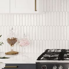 a stove top oven sitting inside of a kitchen next to a vase with flowers on it