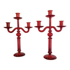 two red candlesticks sitting next to each other