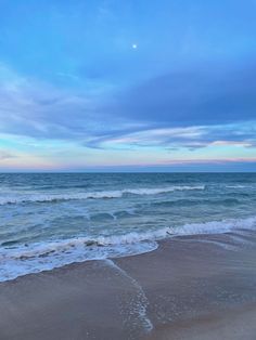 the ocean waves are rolling in to shore