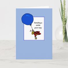 a card with a blue balloon saying sending a smile you're way on it