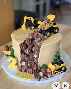 a birthday cake decorated with chocolate and construction vehicles