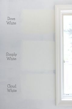 an empty room with white walls and paint samples on the wall next to a window