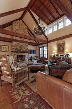 a living room with couches, chairs and a fireplace