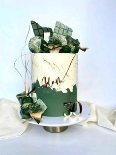 a green and white cake with decorations on top