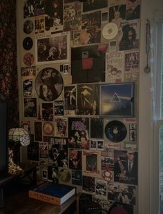 the wall is covered with records and cds