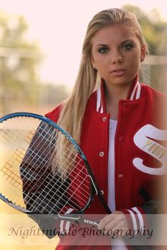 a woman holding a tennis racquet on top of a tennis ball racket