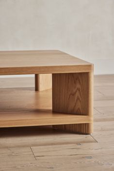 a wooden coffee table sitting on top of a hard wood floor