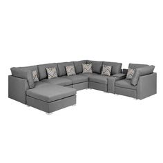 a gray sectional couch with pillows on it