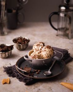 a bowl filled with ice cream sitting on top of a plate