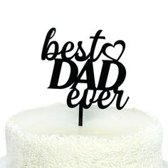 a cake with the words best dad ever on it and a black topper in the shape of a heart