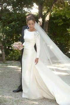 the bride and groom are posing for pictures