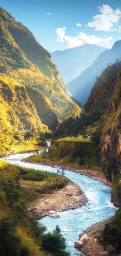 a river flowing through a lush green valley