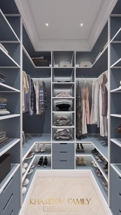 a walk - in closet with blue drawers and shelves filled with clothes, shoes and other items