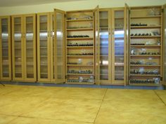 a room filled with lots of wooden cabinets