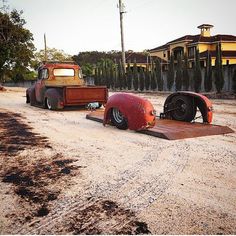 two old trucks are parked on the side of the road