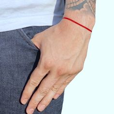 Embrace simplicity and good fortune with our Lucky Red String Bracelet. This minimalist accessory is more than just a fashion statement; it's a symbol of protection, good karma, and energy shielding. Crafted for both casual and sporty wear, it's perfect for daily use. The vibrant red hue not only adds a touch of color to any outfit but also serves as a talisman for attracting good luck and warding off negative energies. Protection From Evil Eye, Sporty Wear, Protection From Evil, Minimalist Accessories, Red String Bracelet, Red String, Good Karma, String Bracelet, Vibrant Red