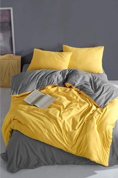 a bed with yellow and grey sheets in a room