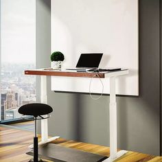 a laptop computer sitting on top of a wooden desk next to a chair in front of a window