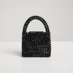 ✮ The Nott Black Crystal Bag, crafted from black crystal beads, reflects the elegance and sophistication of the night  🖤 ✮  The name "Nott" pays homage to the goddess of the night and perfectly captures the bag's refined and striking design. ✮ This chic handbag is an ideal choice for evening events, special occasions, and elegant dinners. ✮   Its crystal details and black color add a touch of sophistication to any outfit and make it a memorable gift for loved ones. Material 🖤   ✮ High-quality Luxury Black Beaded Evening Bag, Evening Top Handle Bag With Beaded Details, Elegant Black Beaded Bags, Chic Black Evening Bag With Rhinestones, Luxury Black Bag With Pearl Handle, Black Bags With Pearl Handle For Gift, Black Evening Bag With Rhinestones, Black Bags With Pearl Handle As Gift, Black Bag With Pearl Handle As Gift