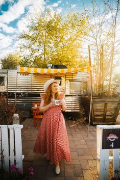 a woman standing in front of a food truck