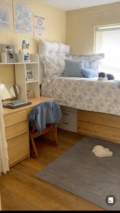 a bedroom with a bed, desk and shelves on the wall next to each other