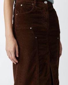 Straight-cut, five-pocket skirt in soft, stretch modal- and cotton-blend corduroy with fine ribbing. Midi-length garment with belt loops at the waist, slit in the middle at the bottom and workwear-inspired topstitching and rivets on the front. Metal zip and tack-button fastening. Long Corduroy Skirt, Corduroy Midi Skirt, Pocket Skirt, Calf Length Skirts, Chestnut Brown, Corduroy Skirt, Casual Blazer, Mid Dresses, Mid Length Dresses