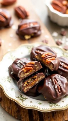 chocolate covered candies on a plate with pecans in the background