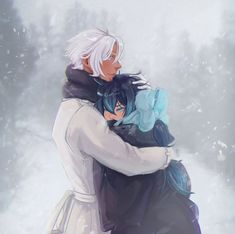 two people hugging each other in the snow