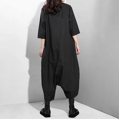 Introducing our Women's Comfortable Chic Black Oversized Jumpsuit, the epitome of effortless style and comfort. This jumpsuit features an oversized silhouette with a wide-leg look, offering both chicness and comfort in one ensemble. Crafted from high-quality fabric, this jumpsuit ensures all-day comfort and ease of movement. Whether you're running errands or meeting friends for brunch, this versatile piece is sure to become a wardrobe favorite. Key Features: Oversized silhouette for effortless s Black Baggy Jumpsuits And Rompers For Summer, Baggy Black Jumpsuits And Rompers For Summer, Black Relaxed Fit Jumpsuits And Rompers For Spring, Black Relaxed Fit Jumpsuits And Rompers For Loungewear, Black Relaxed Fit Jumpsuit For Workwear, Oversized Solid Jumpsuits And Rompers With Pockets, Black Relaxed Fit Wide Leg Jumpsuits And Rompers, Black Relaxed Fit Jumpsuits And Rompers, Oversized Jumpsuits And Rompers For Summer