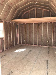 the inside of an unfinished attic with insulation