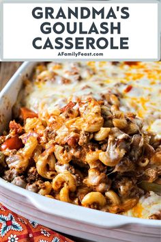 a casserole dish filled with pasta and meat in a white baking dish on top of a colorful cloth